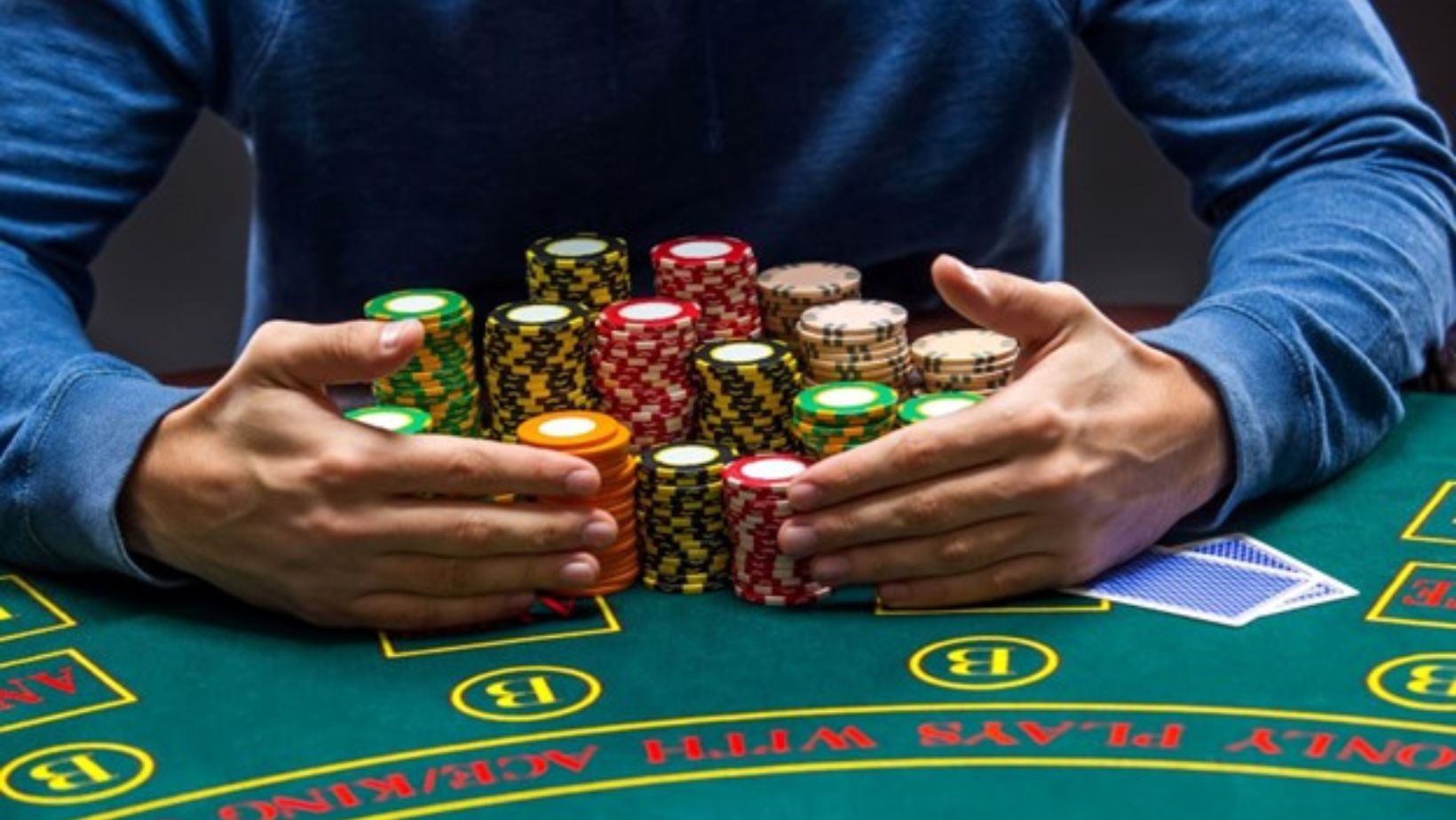 Poker player taking poker chips